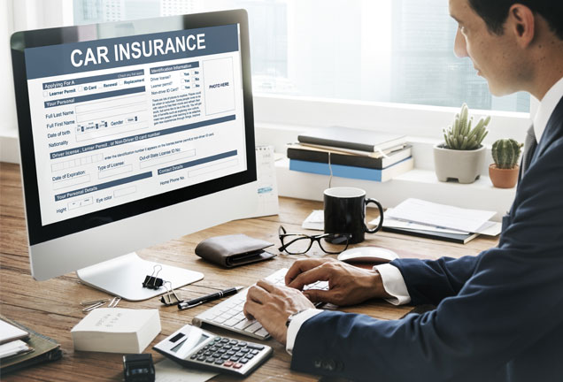 Comparing Auto Insurance Policies on Laptop